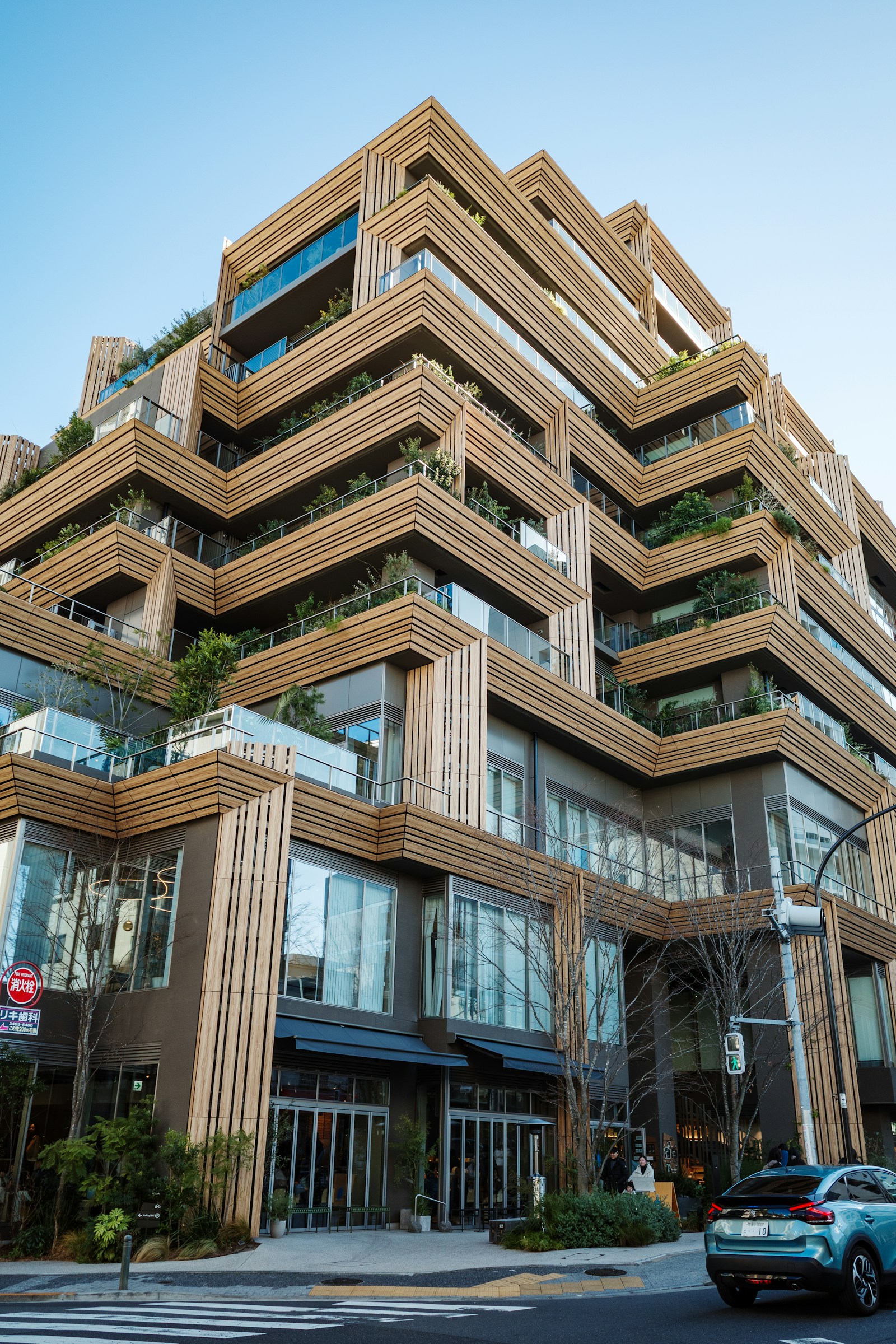Modern residential building with wooden balconies and integrated greenery